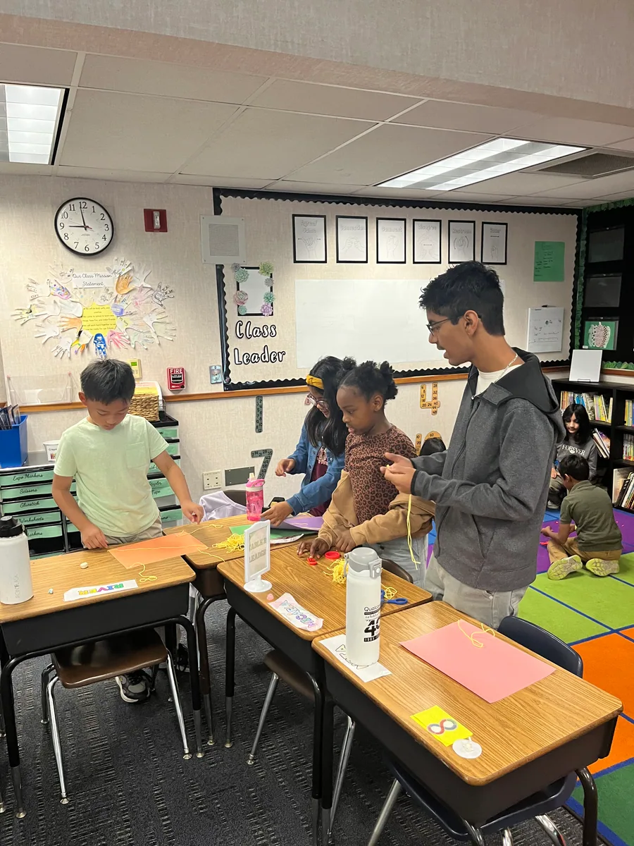 Students building with volunteers